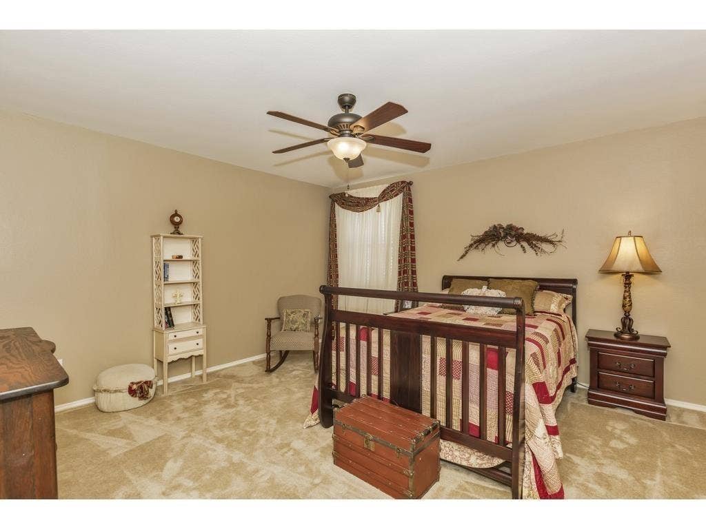 2912 Lake Terrace Drive, Wylie, TX 75098 Bedroom featuring vaulted ceilings, ceiling fan with integrated lighting, carpeted flooring, and a window with valance