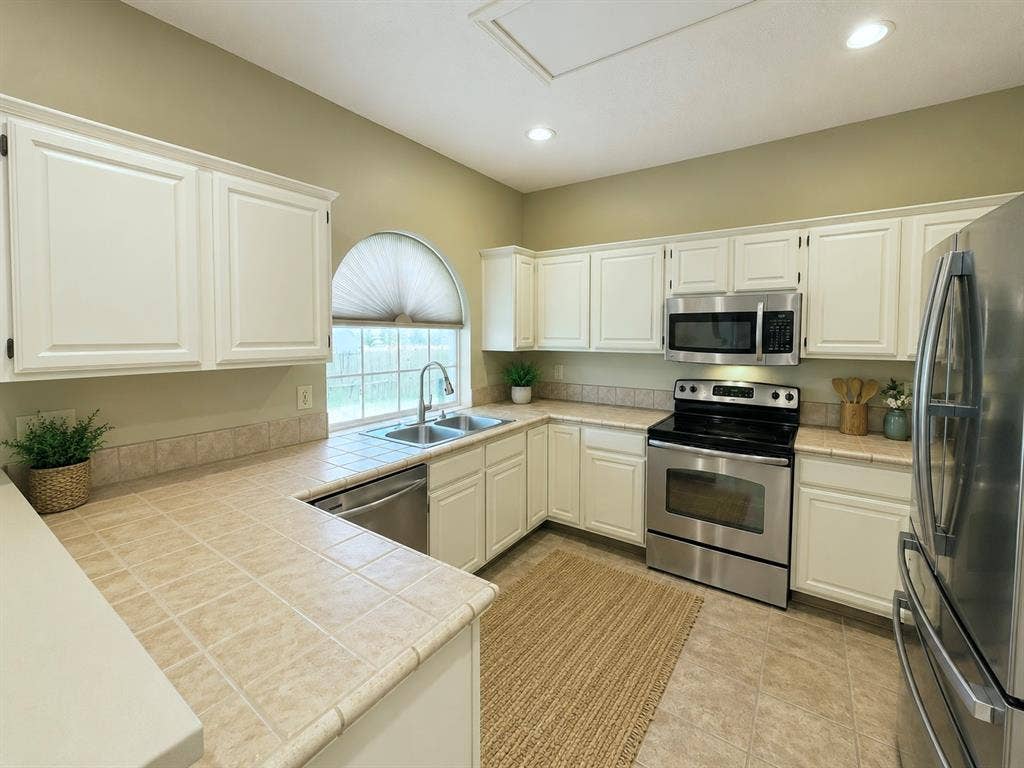 1221 Big Bend Drive, McKinney, TX 75069 Kitchen has stainless appliances, including microwave, range and dishwasher, currently z.