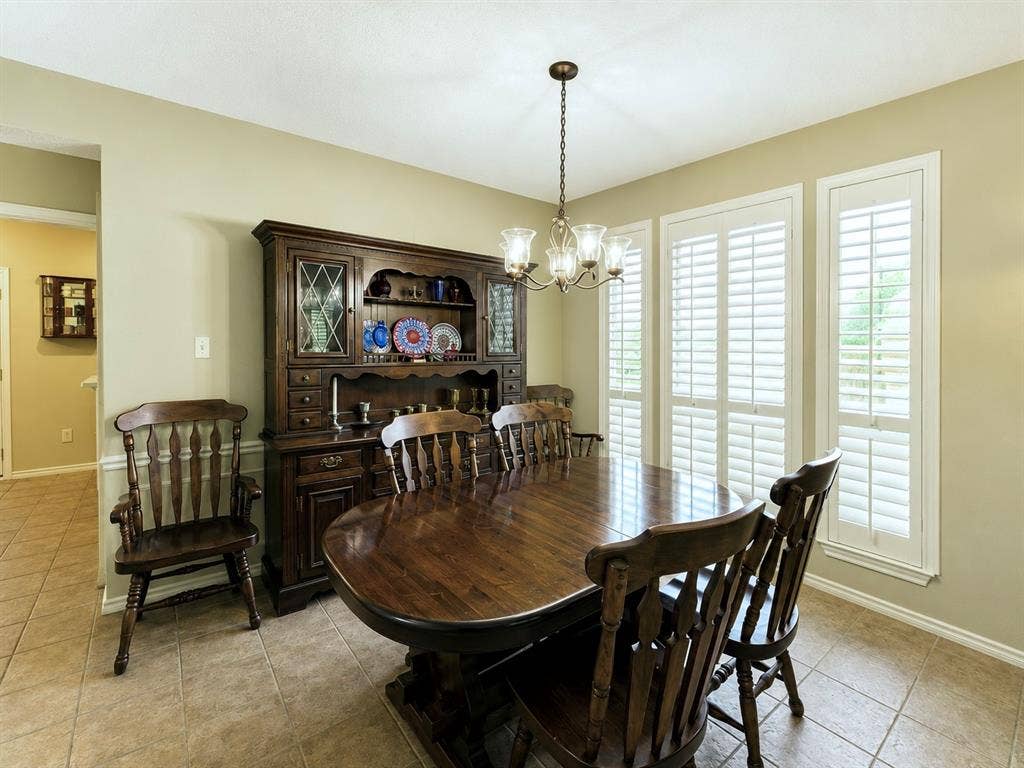 1221 Big Bend Drive, McKinney, TX 75069 Another dining room with large windows covered with plantation shutters viewing Wilson Creek Park from across the boulevard.
