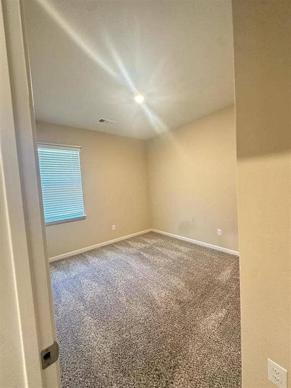 1707 Cotton Blossom Lane, Princeton, TX 75407 Neutral-toned carpeting complements light wall paint in this room featuring a window with horizontal blinds and a ceiling-mounted light fixture