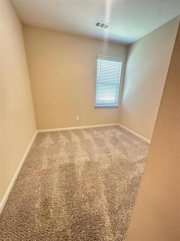 1707 Cotton Blossom Lane, Princeton, TX 75407 Carpeted room featuring neutral wall paint, a single window with blinds, white baseboards, and a ceiling-mounted vent