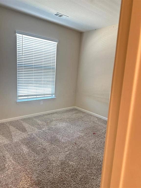 1707 Cotton Blossom Lane, Princeton, TX 75407 Carpeted room featuring a white window blind, light-colored walls, white trim, and a ceiling vent