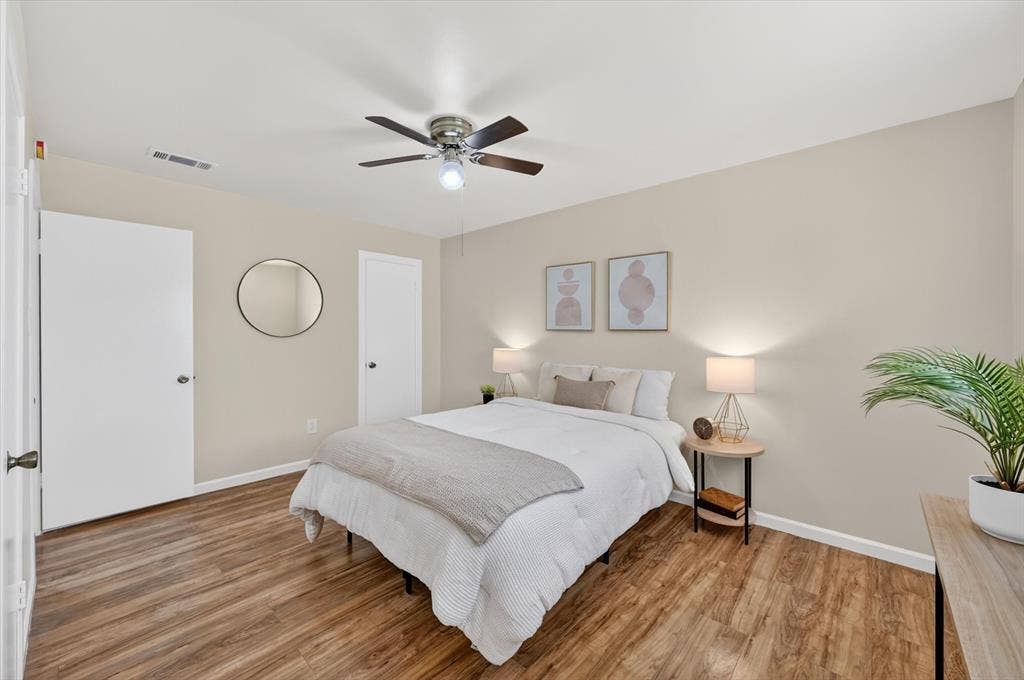 1012 Plover Lane, Arlington, TX 76015 Bedroom featuring wood-finish flooring, neutral wall tones, and white trim
