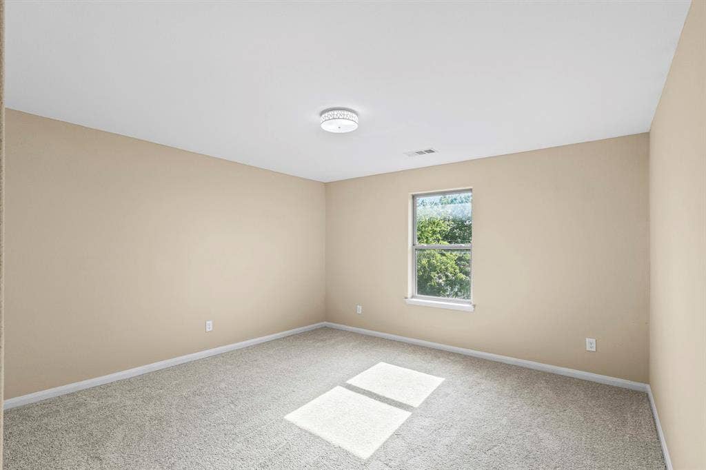 1516 Kinglet Street, DeSoto, TX 75115 Interior room featuring beige walls, light gray carpet, and a flush mount ceiling light