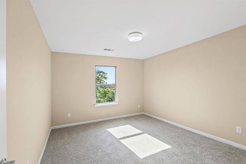 1516 Kinglet Street, DeSoto, TX 75115 Bedroom featuring neutral wall paint, gray carpet flooring, a single window, white trim, and a flush-mount ceiling light fixture