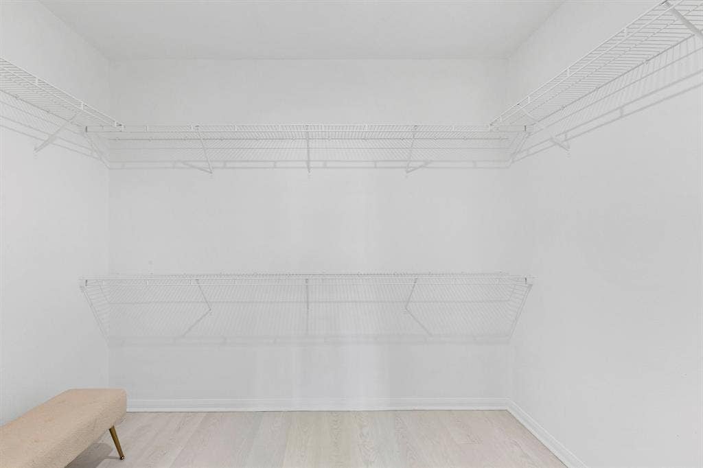 1516 Kinglet Street, DeSoto, TX 75115 Spacious walk-in closet featuring white wire shelving, light wood-finish flooring, and white baseboards