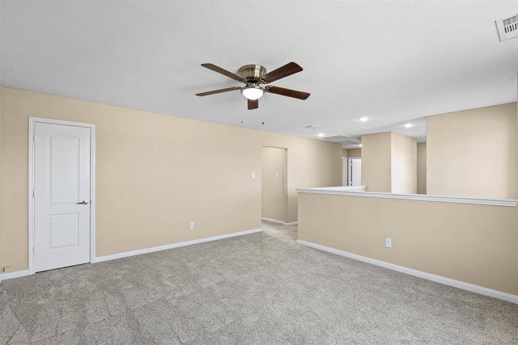 1516 Kinglet Street, DeSoto, TX 75115 Carpeted room featuring a ceiling fan with integrated lighting, recessed lighting, and a half-wall partition