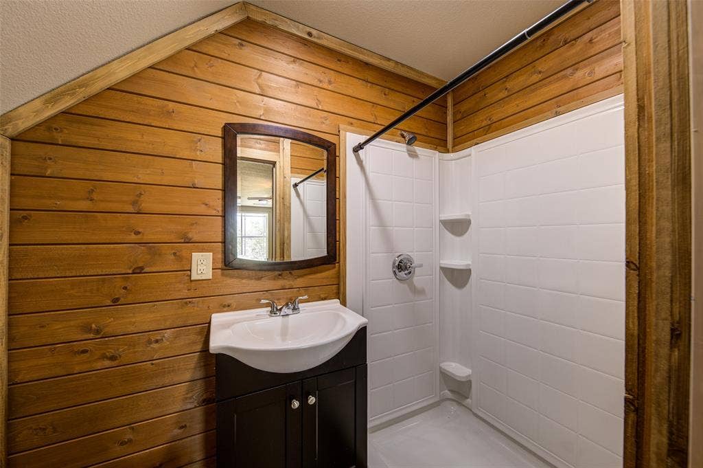 245 Fm 407 W, Argyle, TX 76226 Upstairs Full bath featuring a shower with curtain, vanity, and wooden walls