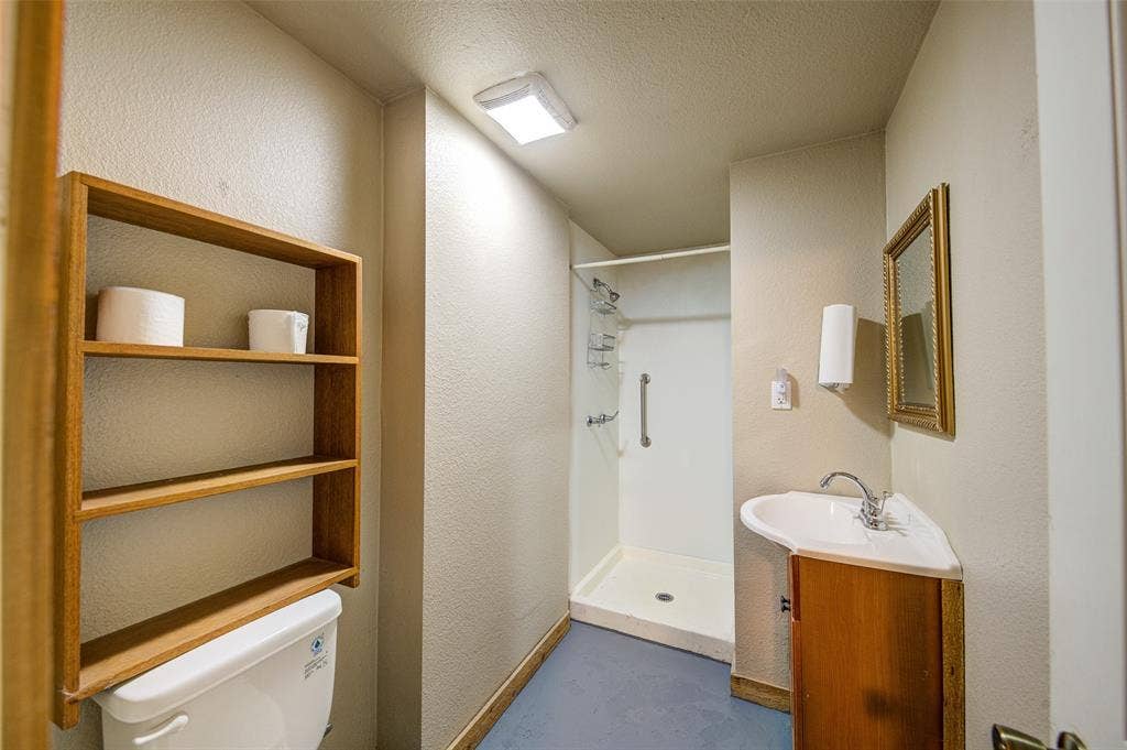245 Fm 407 W, Argyle, TX 76226 Bathroom with a shower stall, vanity, a textured wall, and a textured ceiling