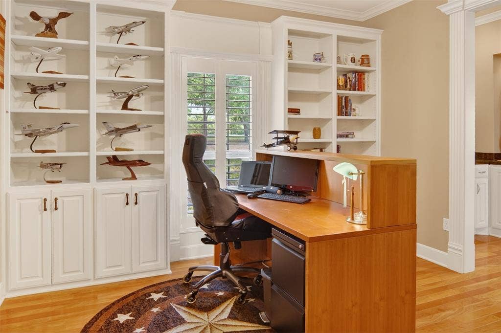 Study with wood flooring and shutters.