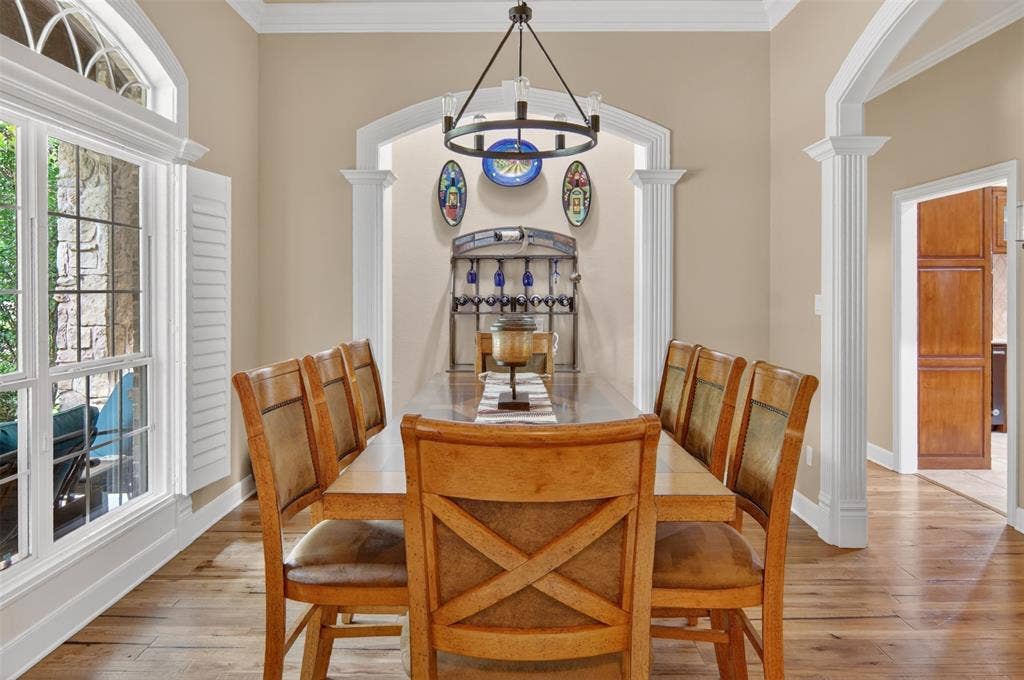 Spacious dining room with wood flooring.