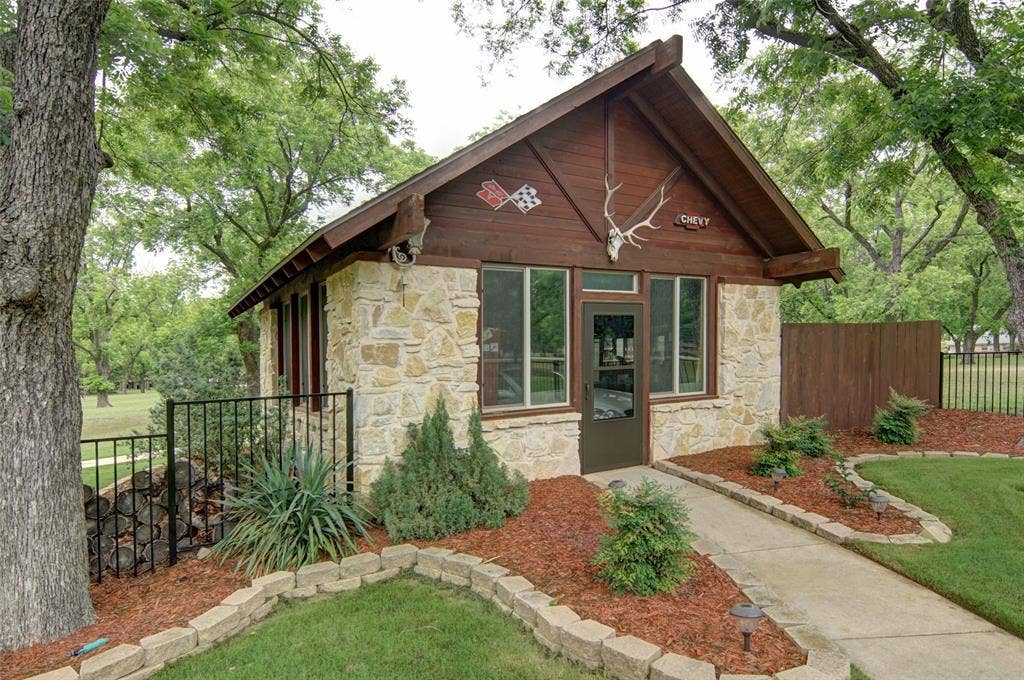 Beautiful stone workshop/detached garage. Don't forget to look at the fireplace inside the workshop.