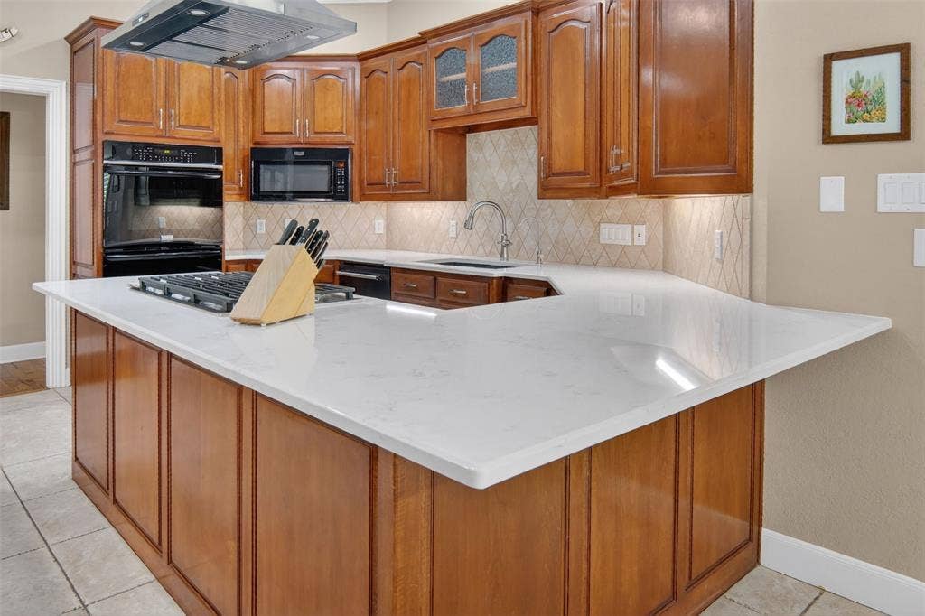 This cook's kitchen is a delight and features large island with gas cooktop, double oven, microwave, and dishwasher.