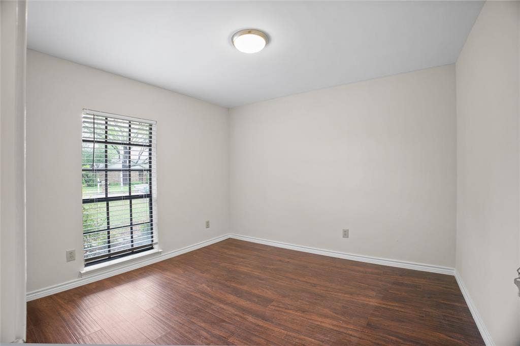 3228 Anchor Drive, Plano, TX 75023 Room featuring wood-finish flooring, white baseboards, and neutral wall tones