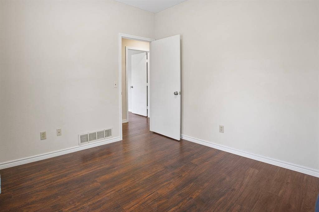 3228 Anchor Drive, Plano, TX 75023 Interior room featuring wood-finish flooring, white baseboards, and light-colored walls