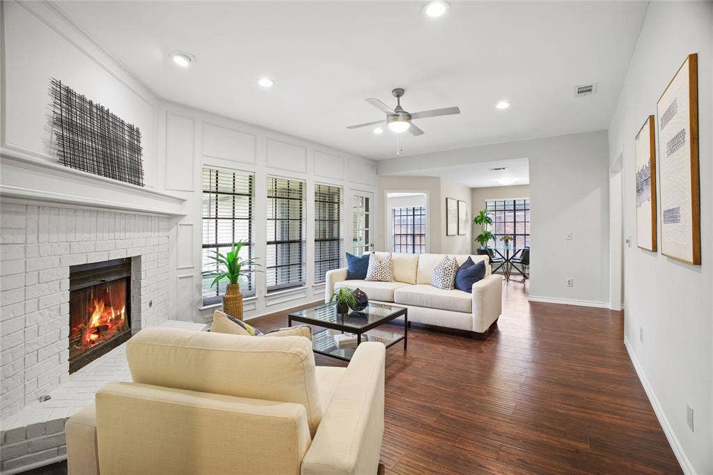 3228 Anchor Drive, Plano, TX 75023 Spacious living area featuring wood-finish flooring and a white brick fireplace