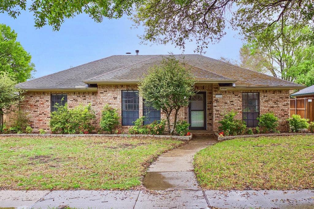 3228 Anchor Drive, Plano, TX 75023 Brick exterior home featuring a curving concrete walkway