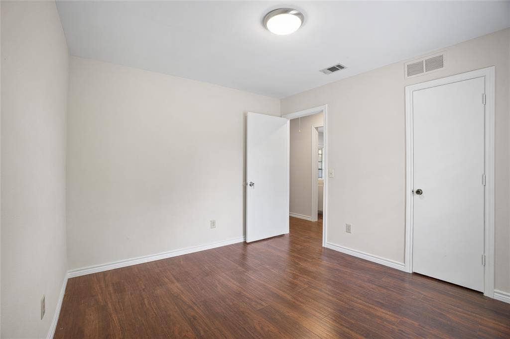 3228 Anchor Drive, Plano, TX 75023 Room featuring wood-finish flooring, light neutral wall paint, and white trim