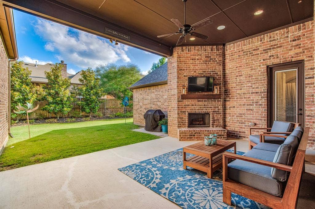 Terrific fireplace, north facing patio with grill pad & beautiful landscape! Low maintenance!