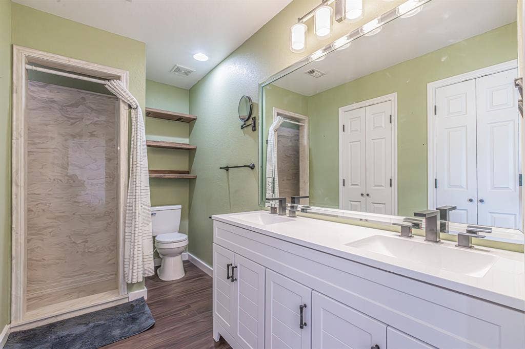 204 S Spring Branch Trail, Springtown, TX 76082 Bathroom featuring a dual vanity with white cabinetry, integrated sinks, and brushed nickel fixtures