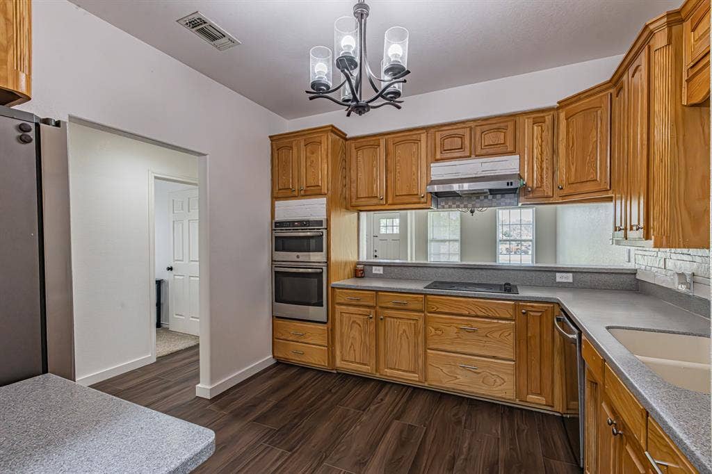 204 S Spring Branch Trail, Springtown, TX 76082 Kitchen featuring wood cabinetry, integrated double ovens, a built-in cooktop, and a stainless steel dishwasher