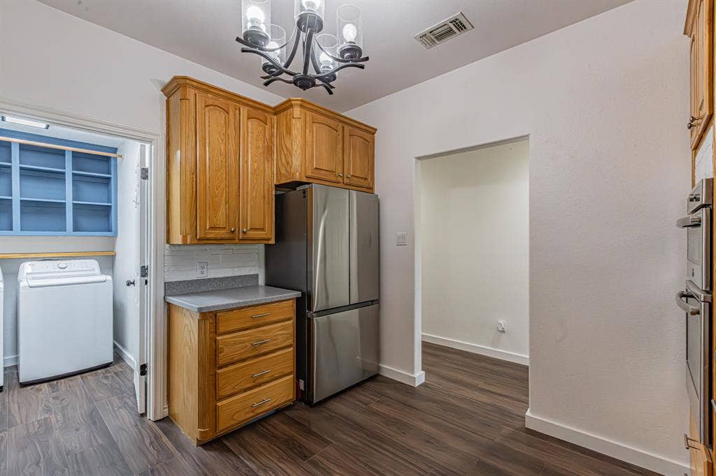 204 S Spring Branch Trail, Springtown, TX 76082 Kitchen area featuring wood-finish flooring and light wood cabinetry with brushed nickel hardware