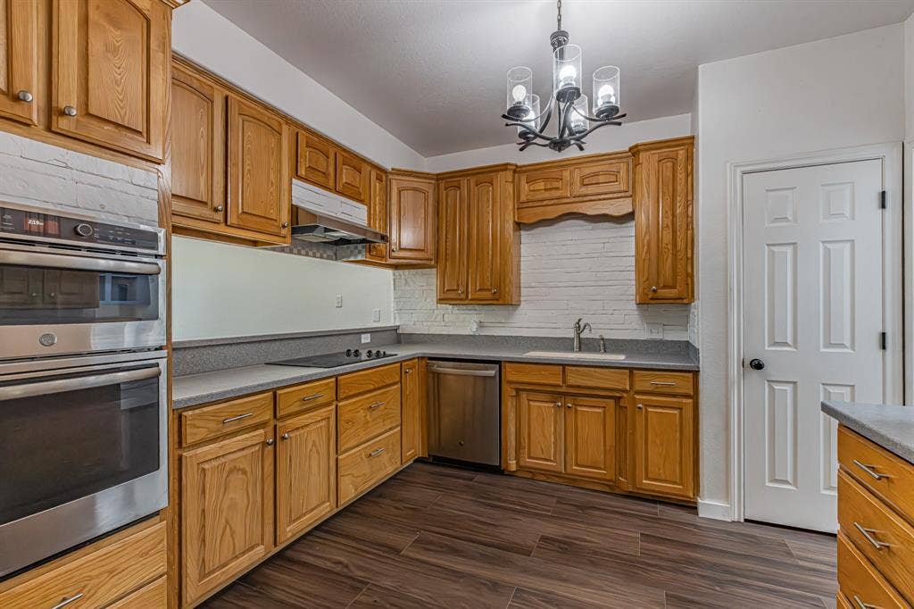 204 S Spring Branch Trail, Springtown, TX 76082 Kitchen featuring wood cabinetry, stainless steel double oven, cooktop, and dishwasher