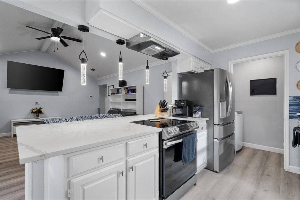 7629 Cedarhill Road, Watauga, TX 76148 Kitchen island featuring a white countertop and white cabinetry with brushed nickel hardware