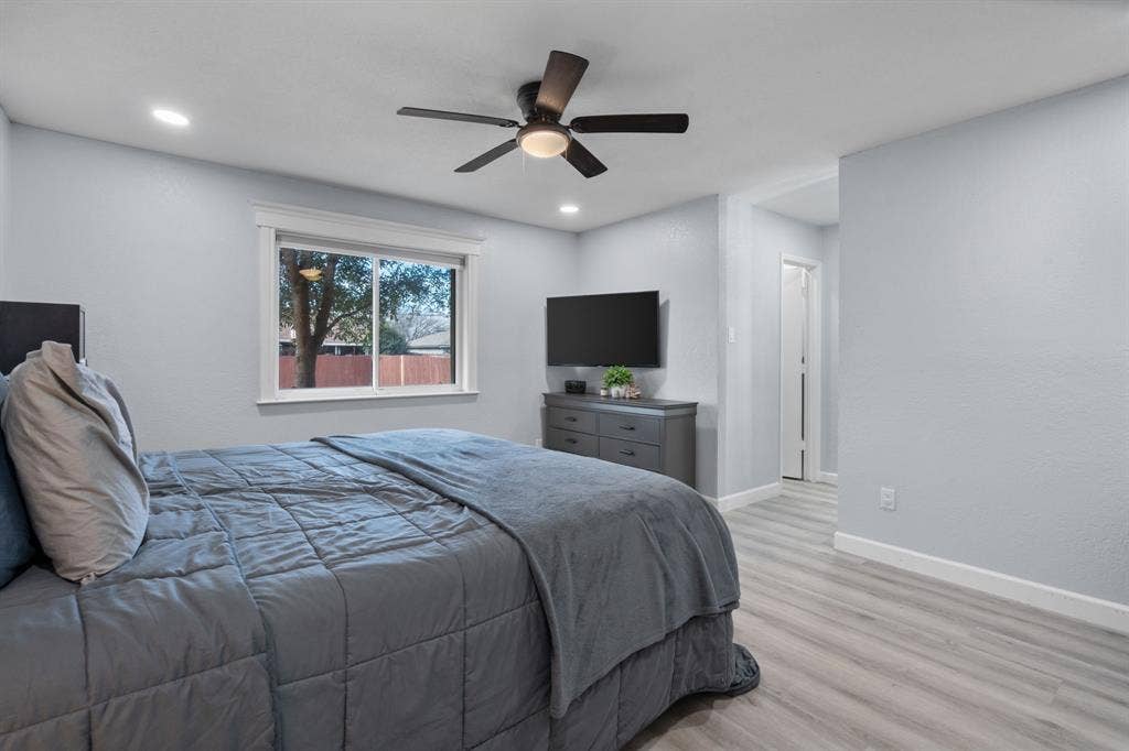 7629 Cedarhill Road, Watauga, TX 76148 Recessed lighting, light gray walls, wood-finish flooring, and a modern ceiling fan with integrated lighting