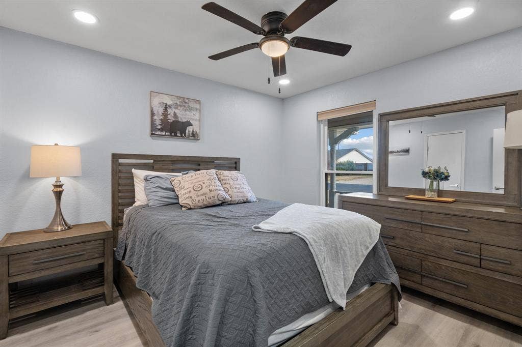 7629 Cedarhill Road, Watauga, TX 76148 Bedroom featuring wood-finish flooring, recessed lighting, and a ceiling fan with integrated light
