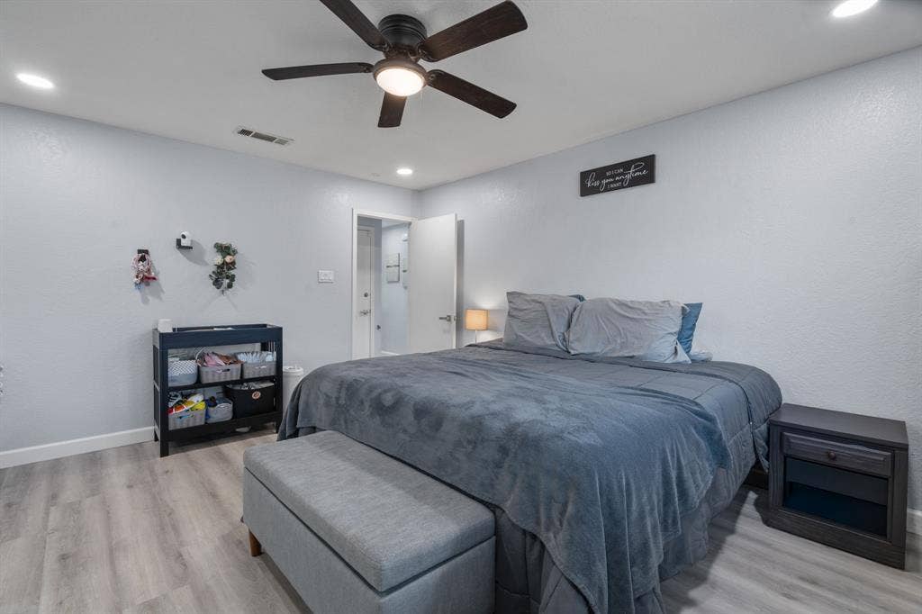 7629 Cedarhill Road, Watauga, TX 76148 Bedroom featuring wood-finish flooring, recessed lighting, and a ceiling fan with integrated light