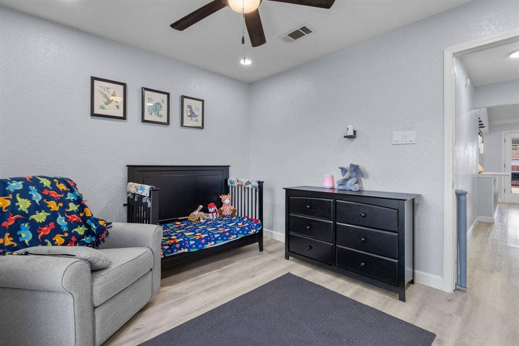 7629 Cedarhill Road, Watauga, TX 76148 Light gray walls complemented by wood-finish flooring