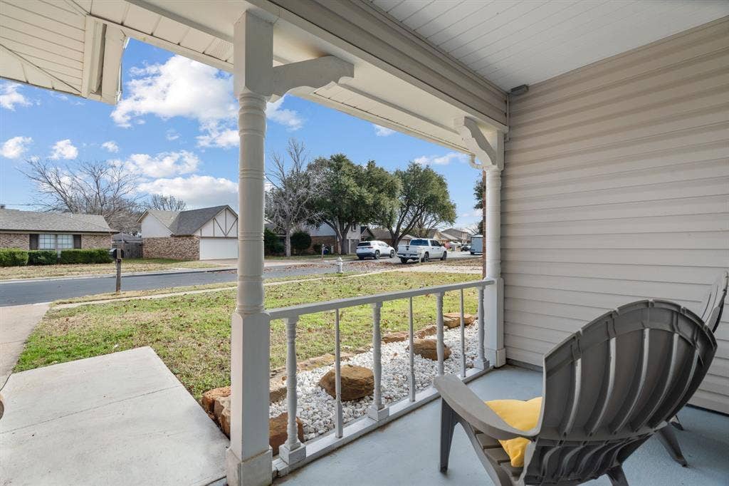 7629 Cedarhill Road, Watauga, TX 76148 Covered front porch featuring white columns and a matching railing
