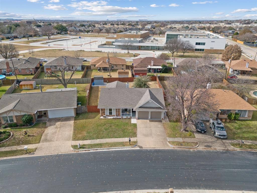 7629 Cedarhill Road, Watauga, TX 76148 Single-story residence featuring a two-car garage, front yard with green space, and a paved driveway