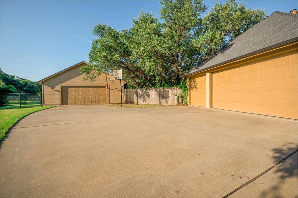 182 Lakeview Drive, Aledo, TX 76008 3 car attached garage, a detached 2 car shop and large concrete area for sports.
