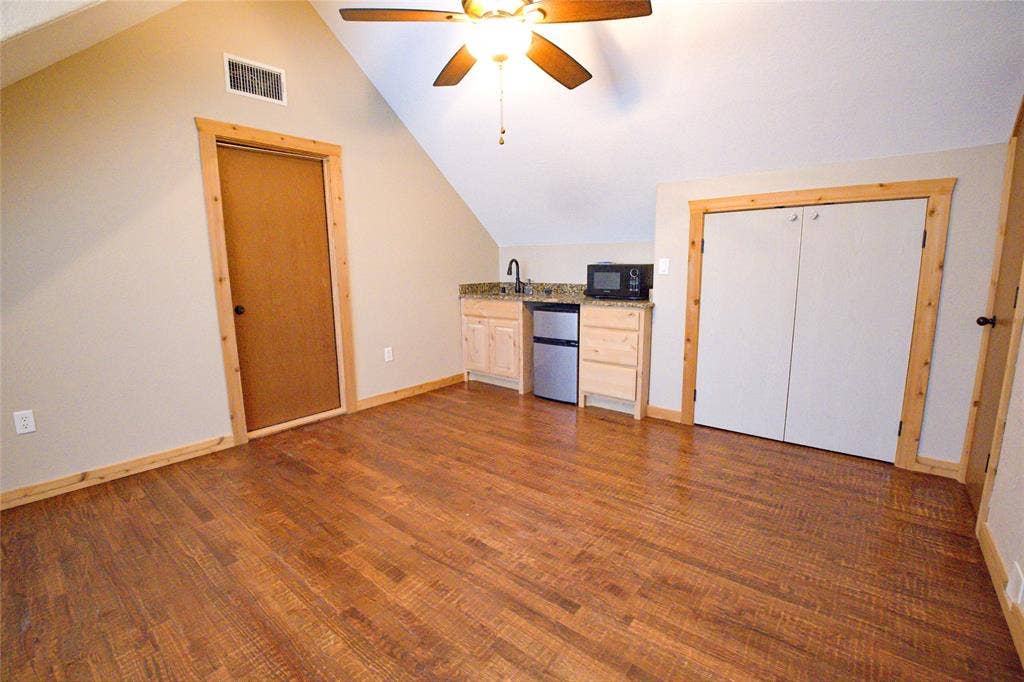 182 Lakeview Drive, Aledo, TX 76008 Upstairs flex room with wet bar & hand scraped red oak floors, could be additional living area or 6th bedroom with closet. 2nd of only 2 rooms upstairs.