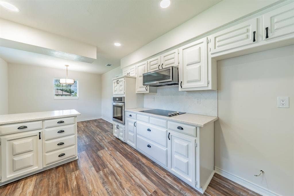 2212 Vickers Drive, Plano, TX 75075 Kitchen featuring white cabinetry, wood-finish flooring, recessed lighting, and a built-in oven with an integrated cooktop