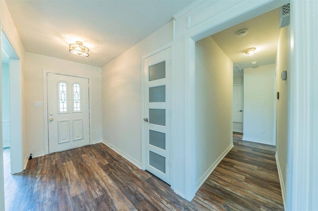 2212 Vickers Drive, Plano, TX 75075 Entryway featuring wood-finish flooring and a decorative flush-mount ceiling fixture