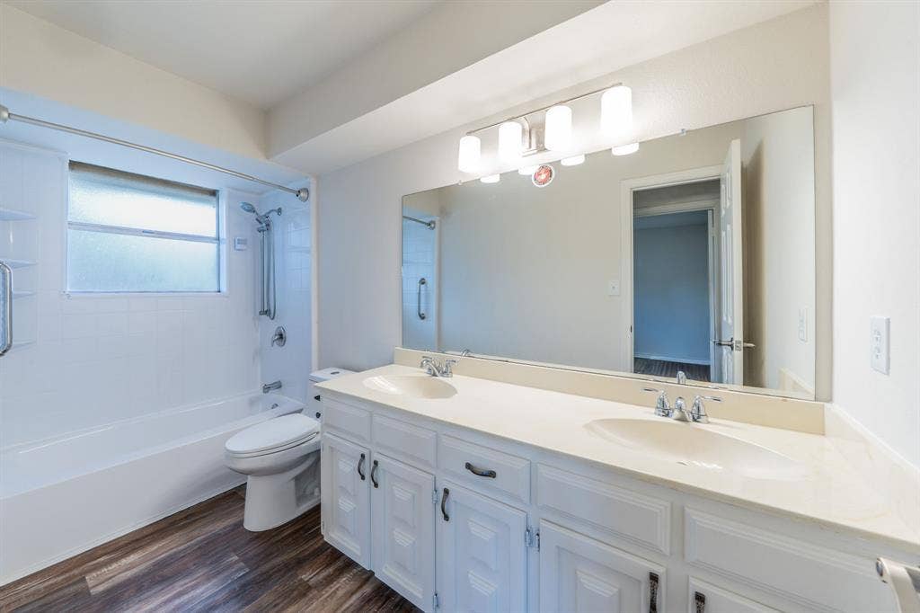 2212 Vickers Drive, Plano, TX 75075 Double vanity with integrated sinks, white cabinetry, and wood-finish flooring