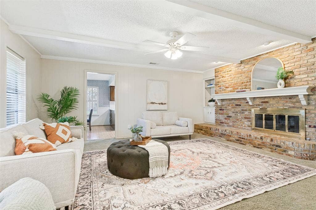 915 Grinnell Drive, Richardson, TX 75081 915 Grinnell Dr. - Spacious den featuring windows overlooking the back porch, a beautiful brick fireplace with built-in storage, and an attached walk-in closet providing exceptional additional storage