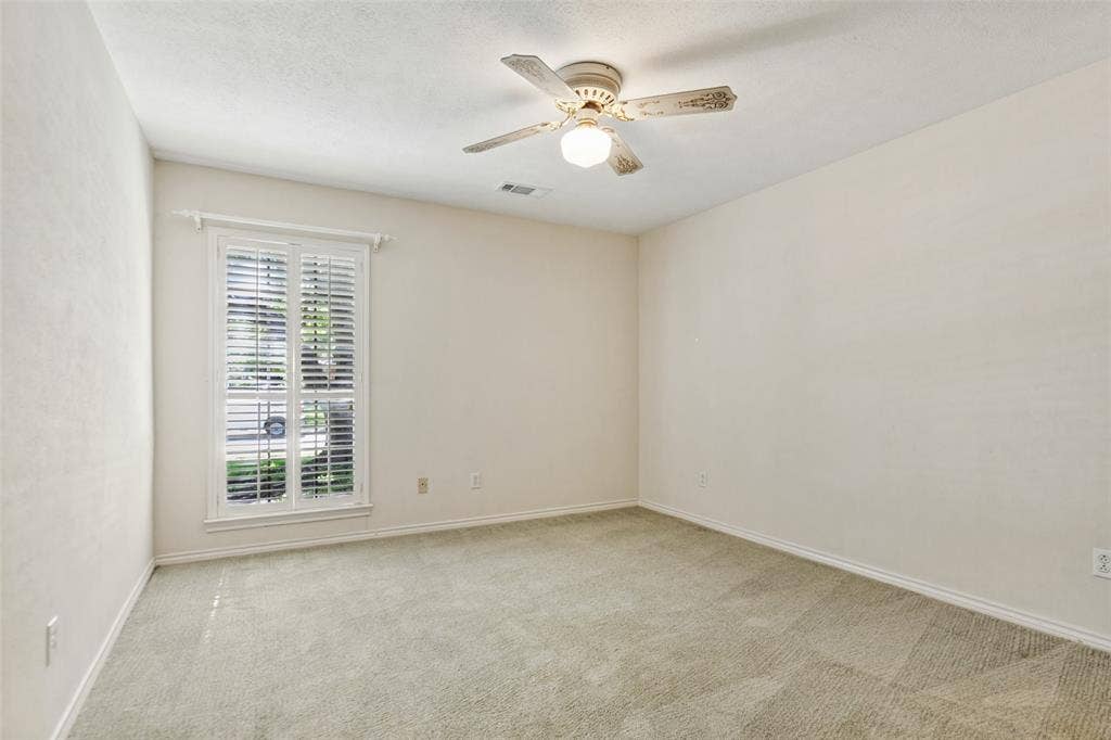 915 Grinnell Drive, Richardson, TX 75081 915 Grinnell Dr. - Bedroom featuring a front-facing window with a plantation shutter, providing natural light and a polished architectural detail.