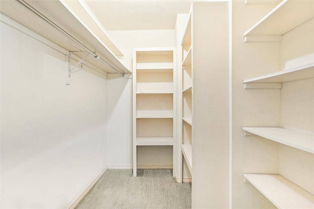 915 Grinnell Drive, Richardson, TX 75081 915 Grinnell Dr. - Large walk-in closet located just off the den, featuring built-in shelving and abundant organized storage.