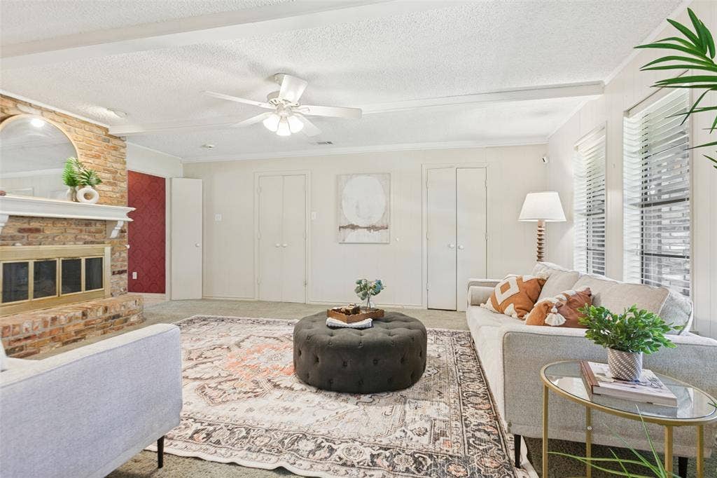 915 Grinnell Drive, Richardson, TX 75081 915 Grinnell Dr. - Spacious den featuring windows overlooking the back porch, a beautiful brick fireplace with built-in storage, and an attached walk-in closet providing exceptional additional storage