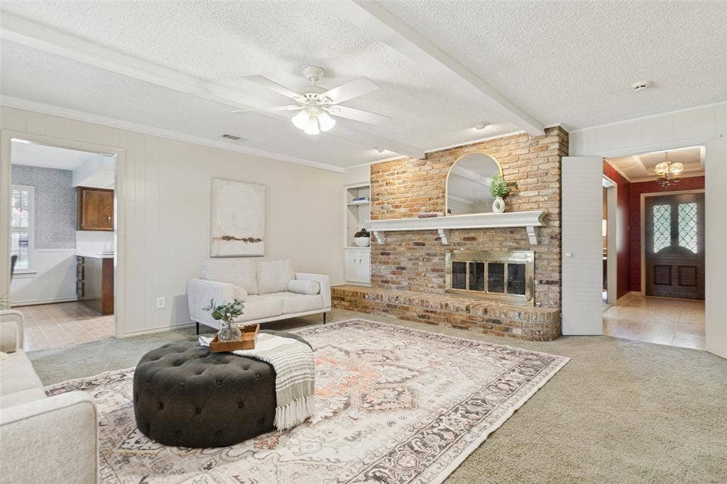 915 Grinnell Drive, Richardson, TX 75081 915 Grinnell Dr. - Spacious den featuring windows overlooking the back porch, a beautiful brick fireplace with built-in storage, and an attached walk-in closet providing exceptional additional storage