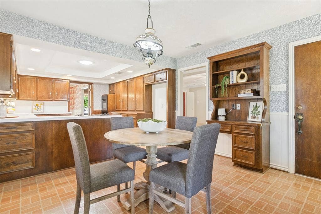 915 Grinnell Drive, Richardson, TX 75081 915 Grinnell Dr. - Breakfast area featuring a large windows overlooking the side and backyards, a solid-wood built-in hutch and desk, and convenient access to the covered back porch.