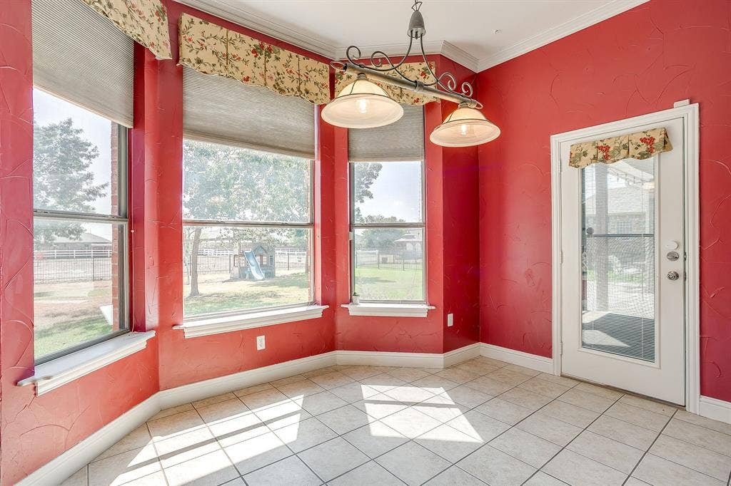 Bay window with multiple large glass panes, tile flooring, and a glass-paneled door