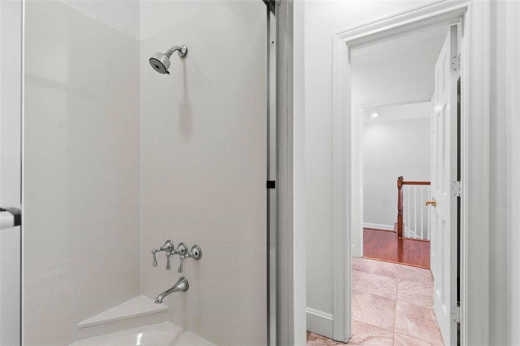 5949 River Bend Drive, Benbrook, TX 76132 Shower with a chrome showerhead and control fixtures, along with a built-in corner shelf