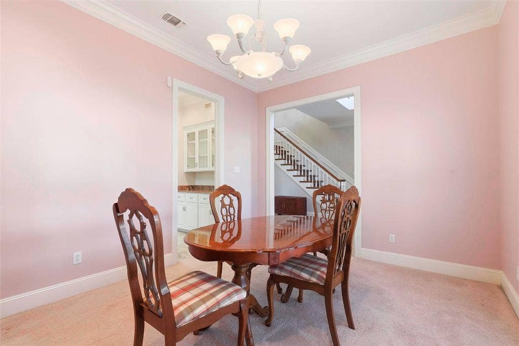 5949 River Bend Drive, Benbrook, TX 76132 Recessed lighting, crown molding, and a chandelier illuminate the carpeted interior with cased openings