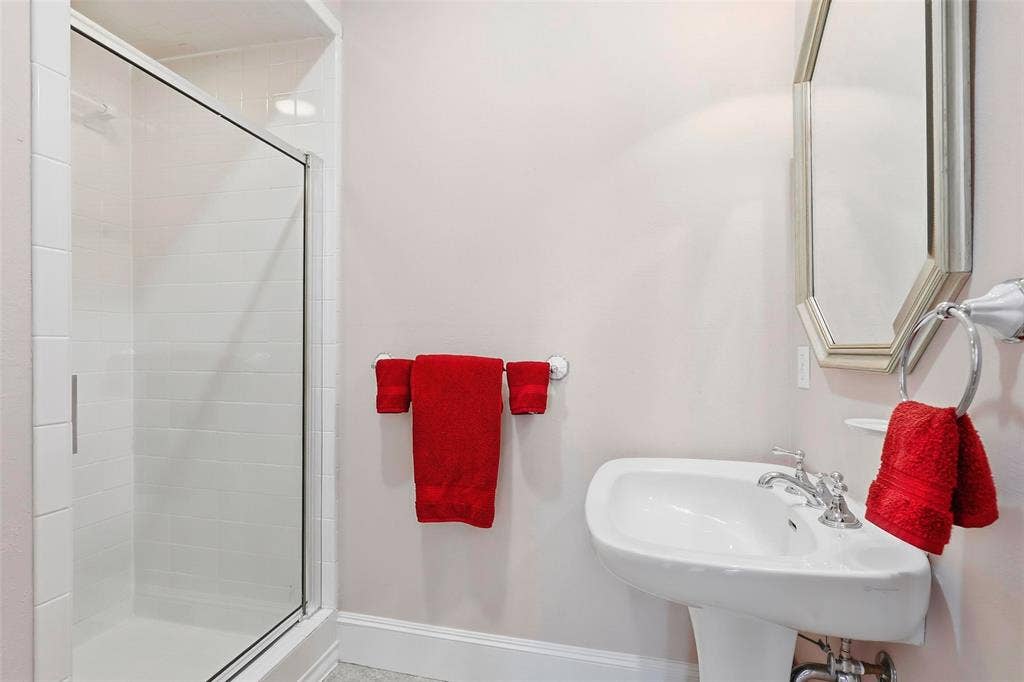 5949 River Bend Drive, Benbrook, TX 76132 Walk-in shower with clear glass enclosure, subway tile surround, and built-in shelving
