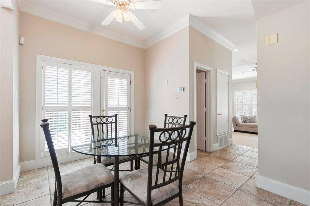 5949 River Bend Drive, Benbrook, TX 76132 Tile flooring, white crown molding, white plantation shutters, and a ceiling fan with light fixture